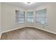 Bright bedroom with large windows, light wood floors, and modern lighting at 404 Hawkstone Way, Alpharetta, GA 30022