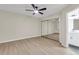 Bright bedroom features a ceiling fan, modern flooring, and mirrored closet doors at 404 Hawkstone Way, Alpharetta, GA 30022