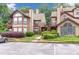 Condominium complex featuring two-story buildings, well-maintained landscaping, and convenient parking spaces at 404 Hawkstone Way, Alpharetta, GA 30022