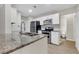 Modern kitchen with granite countertops, white cabinets, stainless steel appliances and stainless steel sink at 404 Hawkstone Way, Alpharetta, GA 30022