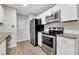 Modern kitchen with stainless steel appliances, granite countertops, and white cabinets at 404 Hawkstone Way, Alpharetta, GA 30022