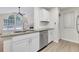 Modern kitchen with granite countertops, stainless steel appliances, and white cabinets at 404 Hawkstone Way, Alpharetta, GA 30022