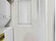 Functional laundry area with stacked washer/dryer and additional storage space at 404 Hawkstone Way, Alpharetta, GA 30022