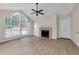 Cozy living room featuring lots of natural light, fireplace, ceiling fan, and a bright white front door at 404 Hawkstone Way, Alpharetta, GA 30022