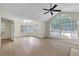 Bright living room featuring light wood floors, lots of natural light from large windows, and a ceiling fan at 404 Hawkstone Way, Alpharetta, GA 30022