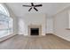 Bright living room featuring lots of natural light, fireplace, ceiling fan, and a bright white front door at 404 Hawkstone Way, Alpharetta, GA 30022