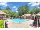 Relaxing pool area with various lounge chairs and umbrellas under a blue sky at 404 Hawkstone Way, Alpharetta, GA 30022