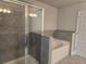 Luxurious bathroom boasts a separate shower and tub with elegant tile surround at 5715 Rocky Falls Drive, Suwanee, GA 30024