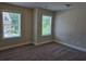 Cozy bedroom features neutral walls, plush carpet, and windows allowing natural light at 5715 Rocky Falls Drive, Suwanee, GA 30024