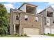Charming brick townhome with a two-car garage and a balcony on the second floor at 5715 Rocky Falls Drive, Suwanee, GA 30024