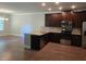 Modern kitchen with granite countertops, stainless steel appliances, and dark wood cabinets at 5715 Rocky Falls Drive, Suwanee, GA 30024