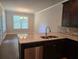 Modern kitchen with granite countertops, stainless steel appliances, and dark wood cabinets at 5715 Rocky Falls Drive, Suwanee, GA 30024
