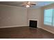 Bright living room features a fireplace, hardwood floors, and recessed lighting at 5715 Rocky Falls Drive, Suwanee, GA 30024