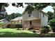 Expansive backyard with a deck, complemented by lush greenery and mature trees at 1380 Ashbrook Dr, Lawrenceville, GA 30043