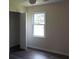 Bright bedroom with ceiling fan, closet and window view to a green backyard at 1380 Ashbrook Dr, Lawrenceville, GA 30043