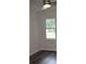 A bright bedroom with modern ceiling fan, wood laminate flooring, and natural light at 1380 Ashbrook Dr, Lawrenceville, GA 30043