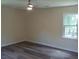 A bright bedroom with modern ceiling fan, wood laminate flooring, and natural light at 1380 Ashbrook Dr, Lawrenceville, GA 30043