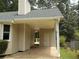 Exterior view showcasing a convenient carport with access to a door and a glimpse of the backyard area at 1380 Ashbrook Dr, Lawrenceville, GA 30043