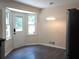 Sunlit breakfast nook features sleek tile flooring, modern lighting, and stainless steel refrigerator at 1380 Ashbrook Dr, Lawrenceville, GA 30043
