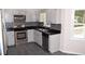 This is a gorgeous kitchen featuring gray cabinets, stainless steel appliances, and tiled backsplash at 1380 Ashbrook Dr, Lawrenceville, GA 30043