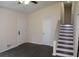 The living room showcases sleek dark floors, a modern ceiling fan, and direct access to the staircase, offering seamless transition at 1380 Ashbrook Dr, Lawrenceville, GA 30043