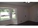 The living room features a large bay window, sleek floors, and convenient access to an exterior door, offering bright living space at 1380 Ashbrook Dr, Lawrenceville, GA 30043
