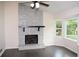 The living room features a striking stone fireplace, large windows, and dark hardwood floors, creating a cozy atmosphere at 1380 Ashbrook Dr, Lawrenceville, GA 30043