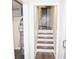Basement stairway featuring updated flooring and access to laundry and storage areas at 1380 Ashbrook Dr, Lawrenceville, GA 30043