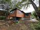 Unique two-story home featuring wood siding and an elevated design, blending modern aesthetics with natural surroundings at 1422 Boulevard Se, Atlanta, GA 30315