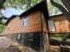 Charming home featuring wood siding, black brick foundation and a unique elevated design, in a lush, natural setting at 1422 Boulevard Se, Atlanta, GA 30315