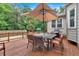 Outdoor back deck with large umbrella table set and a grill, perfect for outdoor entertaining and relaxing at 3656 Ebenezer Rd, Marietta, GA 30066