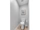Cozy half bathroom featuring a toilet, wall art and a tiled floor at 3656 Ebenezer Rd, Marietta, GA 30066