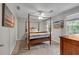 Cozy bedroom with a four-poster bed, ceiling fan, and natural light at 3656 Ebenezer Rd, Marietta, GA 30066