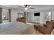 Bedroom with natural light, sitting area, TV, wood floors, and view of the lush backyard at 3656 Ebenezer Rd, Marietta, GA 30066