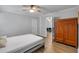 Cozy bedroom with a wood armoire, ceiling fan, and a view into the living room at 3656 Ebenezer Rd, Marietta, GA 30066