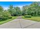Long concrete driveway leading through a lush, green landscape to the main house at 3656 Ebenezer Rd, Marietta, GA 30066