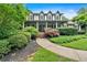 Charming home entrance with a covered porch, brick steps, and lush greenery at 3656 Ebenezer Rd, Marietta, GA 30066