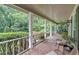 Relaxing covered front porch with brick flooring and comfortable seating area at 3656 Ebenezer Rd, Marietta, GA 30066