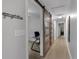 Hallway featuring barn doors that lead to an office and light hardwood floors at 3656 Ebenezer Rd, Marietta, GA 30066