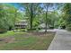 Home with a detached garage, lush landscaping and a long driveway at 3656 Ebenezer Rd, Marietta, GA 30066