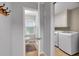 A bright hallway laundry room with a bathroom at the end of the hall at 3656 Ebenezer Rd, Marietta, GA 30066