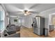 Open living room features a ceiling fan, hardwood floors, and grey furnishings at 3656 Ebenezer Rd, Marietta, GA 30066