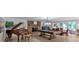 Spacious living room with a piano, pool table, fireplace, and abundant natural light at 3656 Ebenezer Rd, Marietta, GA 30066
