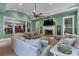 Beautiful living room with fireplace, TV, light green colored walls, and modern furniture at 3656 Ebenezer Rd, Marietta, GA 30066