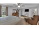 Main bedroom with ceiling fan, dresser, closet, TV, and lots of natural light at 3656 Ebenezer Rd, Marietta, GA 30066