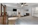 Bright main bedroom features a ceiling fan, dresser, TV, and en suite bathroom at 3656 Ebenezer Rd, Marietta, GA 30066