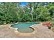 A private in-ground pool with an adjacent sunbathing and entertainment area, surrounded by mature trees at 3656 Ebenezer Rd, Marietta, GA 30066