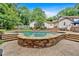 An in-ground pool with stone trim, surrounded by a spacious patio and mature landscaping for a relaxing backyard at 3656 Ebenezer Rd, Marietta, GA 30066