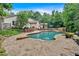 An in-ground pool with ample patio space is surrounded by lush landscaping, offering a private oasis at 3656 Ebenezer Rd, Marietta, GA 30066