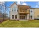 Two-story home featuring a spacious backyard and a charming wooden balcony, perfect for outdoor relaxation and entertainment at 4770 Briscoe Dr, Cumming, GA 30028